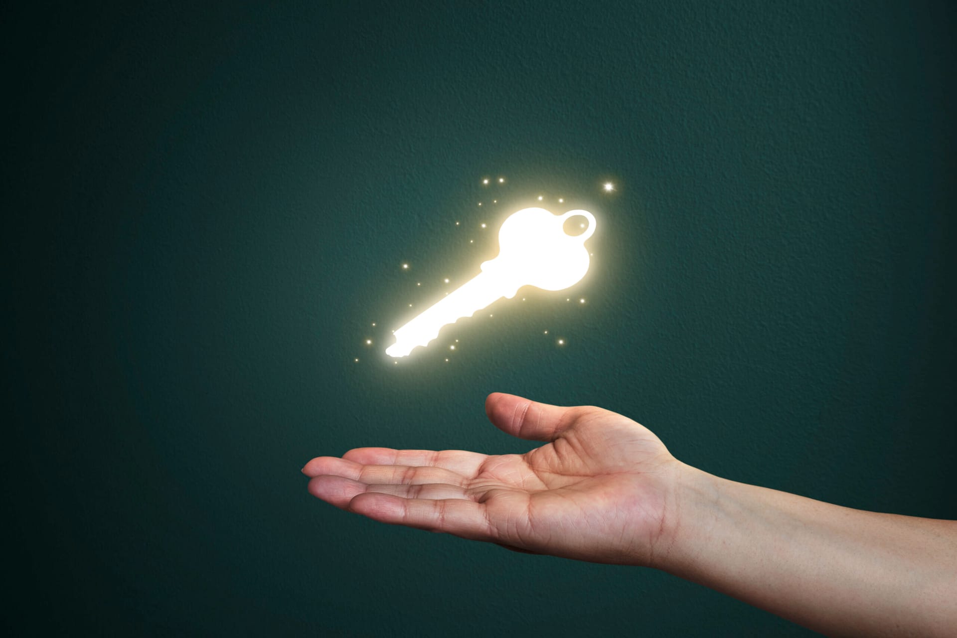 Hand holding magical hovering key symbolizing start of author journey