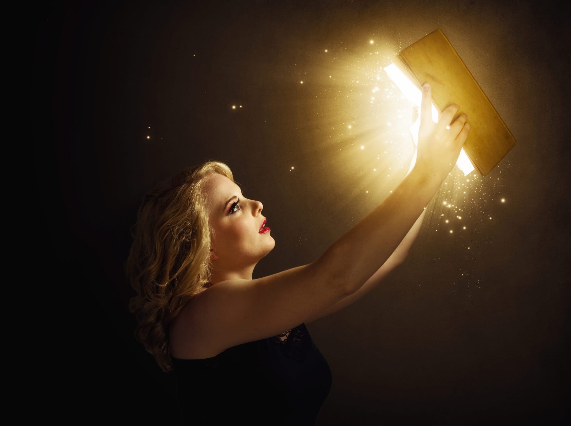 Woman reading magical book showing fantasy and magical realism blend in literature